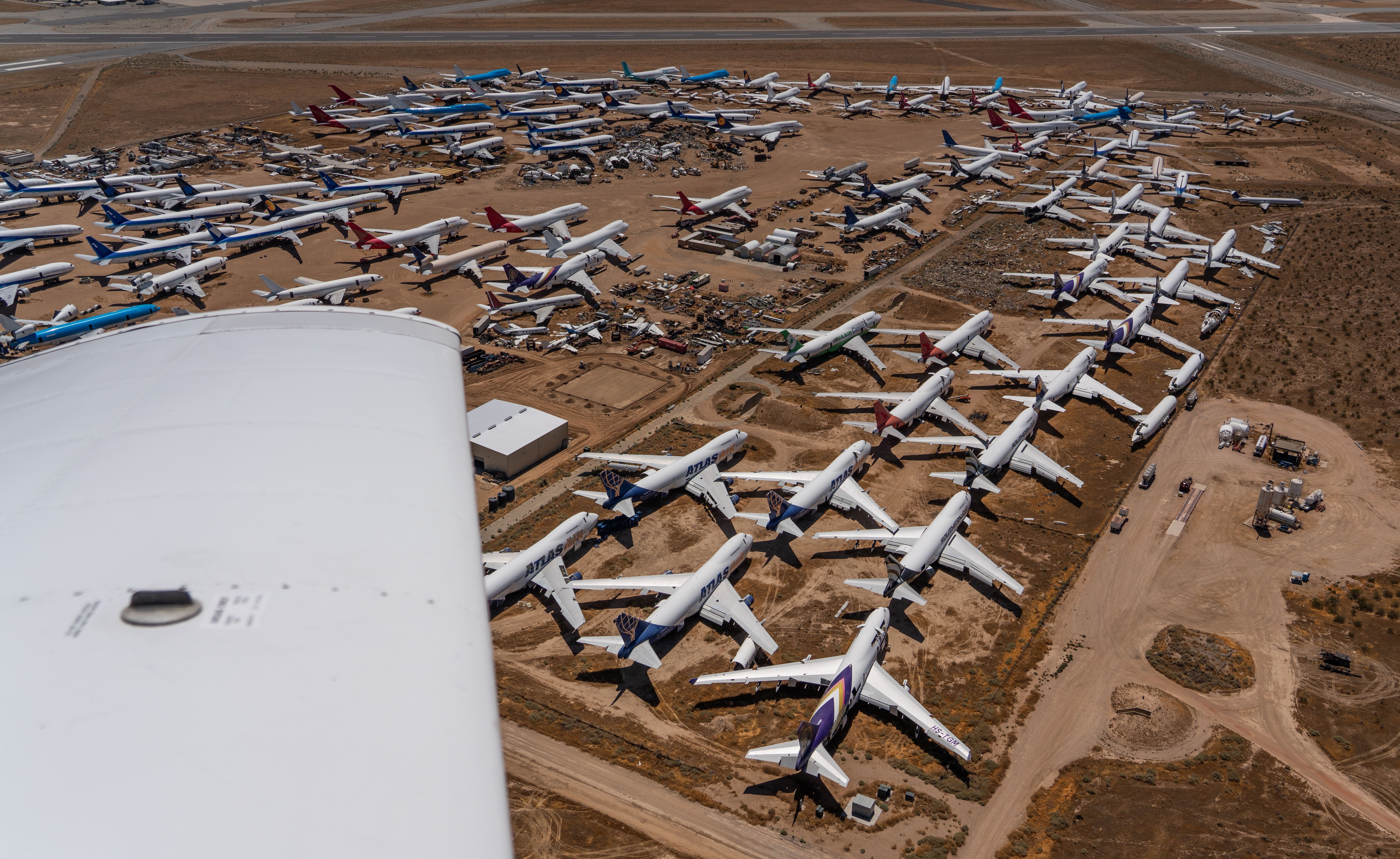 Mojave, CA, USA -7-3-24, aerial landscape view of landscape around airplane storage area at Mojave Air and Space Port at Rutan Field with many retired passenger and cargo aircrafts stored in desert