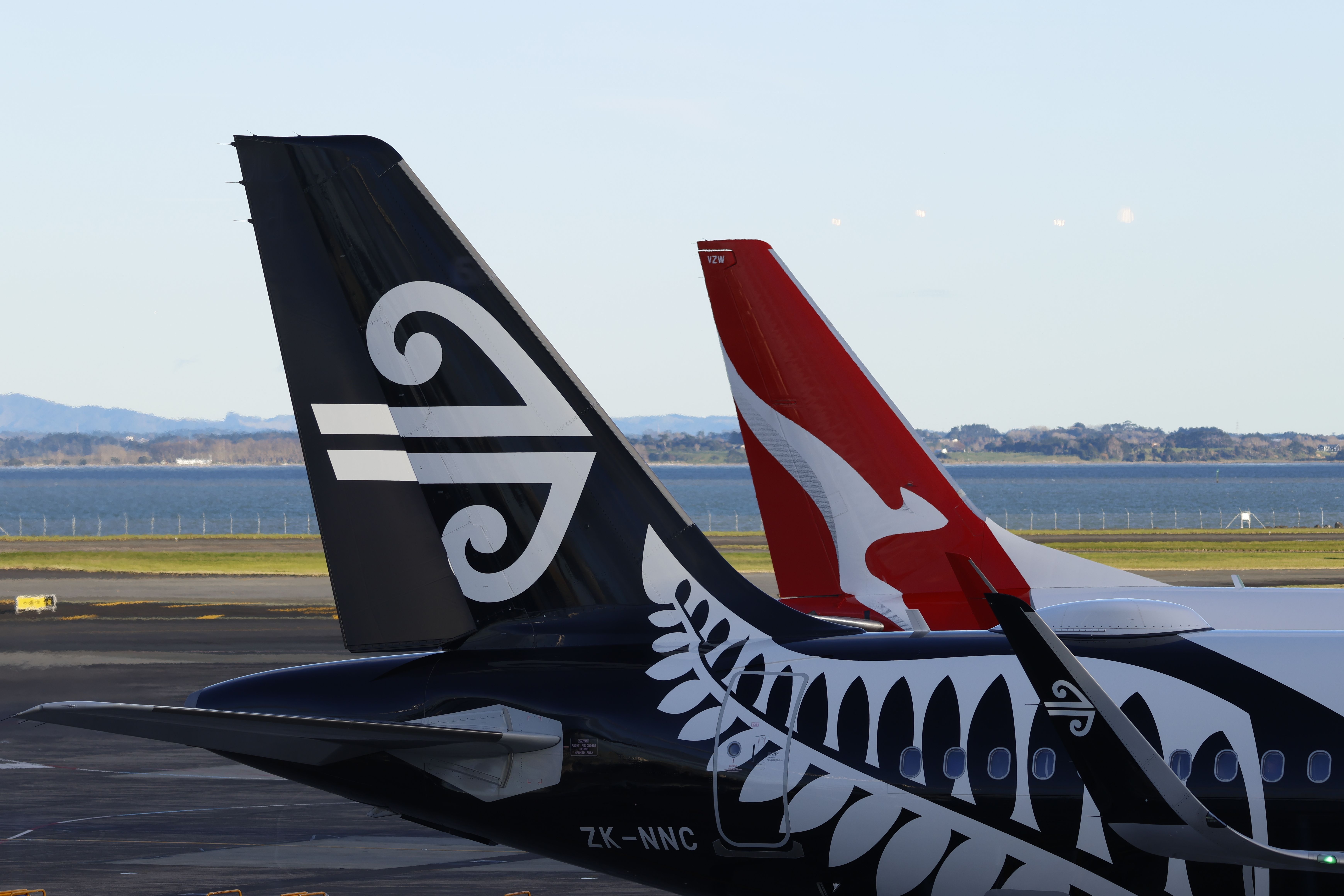 Air New Zealand and Qantas aircraft at Auckland Airport AKL shutterstock_2325689421