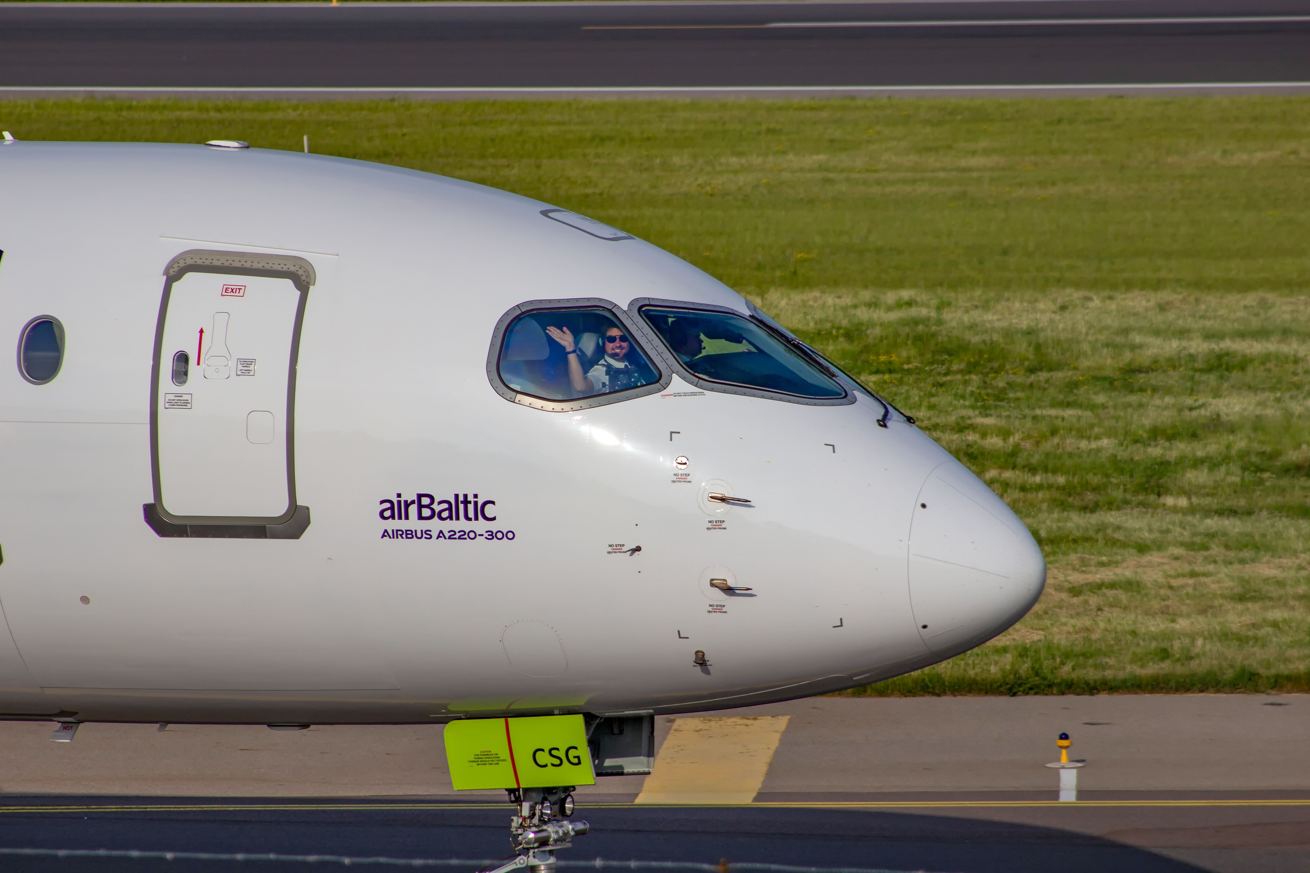 airBaltic Airbus A220-300 taxiing at Vilnius Airport VNO shutterstock_2049987299
