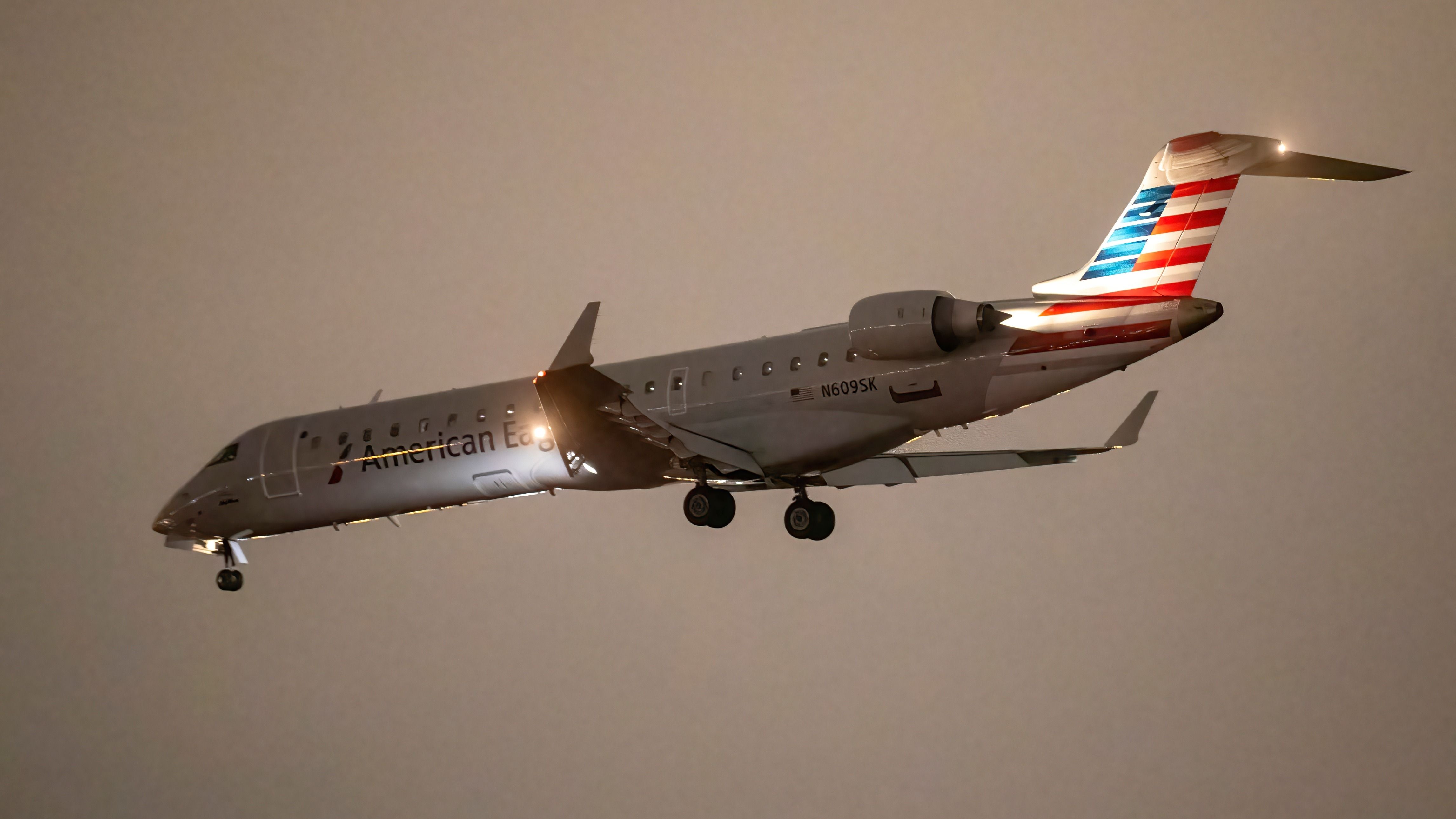 American Eagle Mitsubishi CRJ700 landing at LAX shutterstock_2575911787