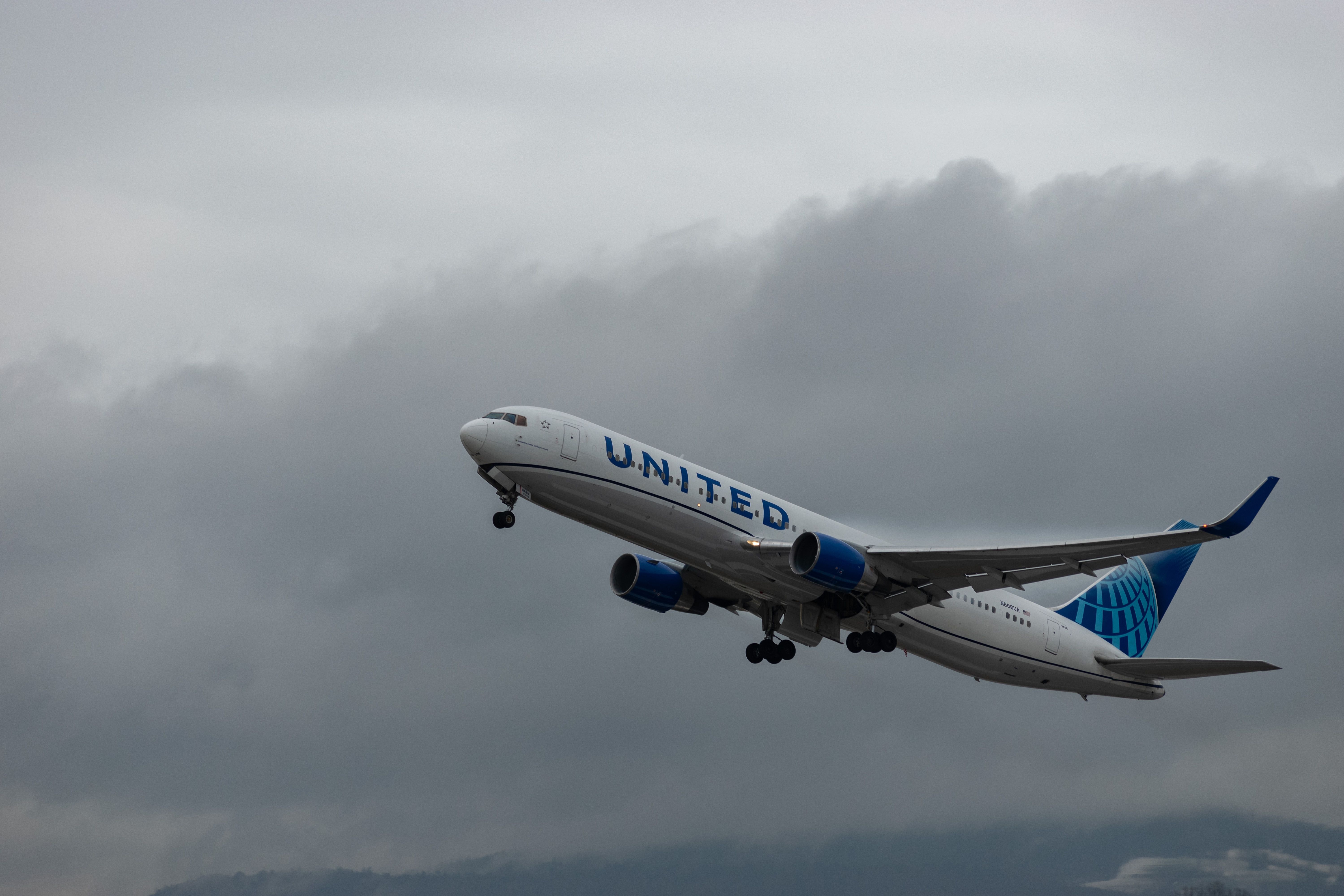 N-666UA United airlines Boeing 767-322ER aircraft during a rain shower