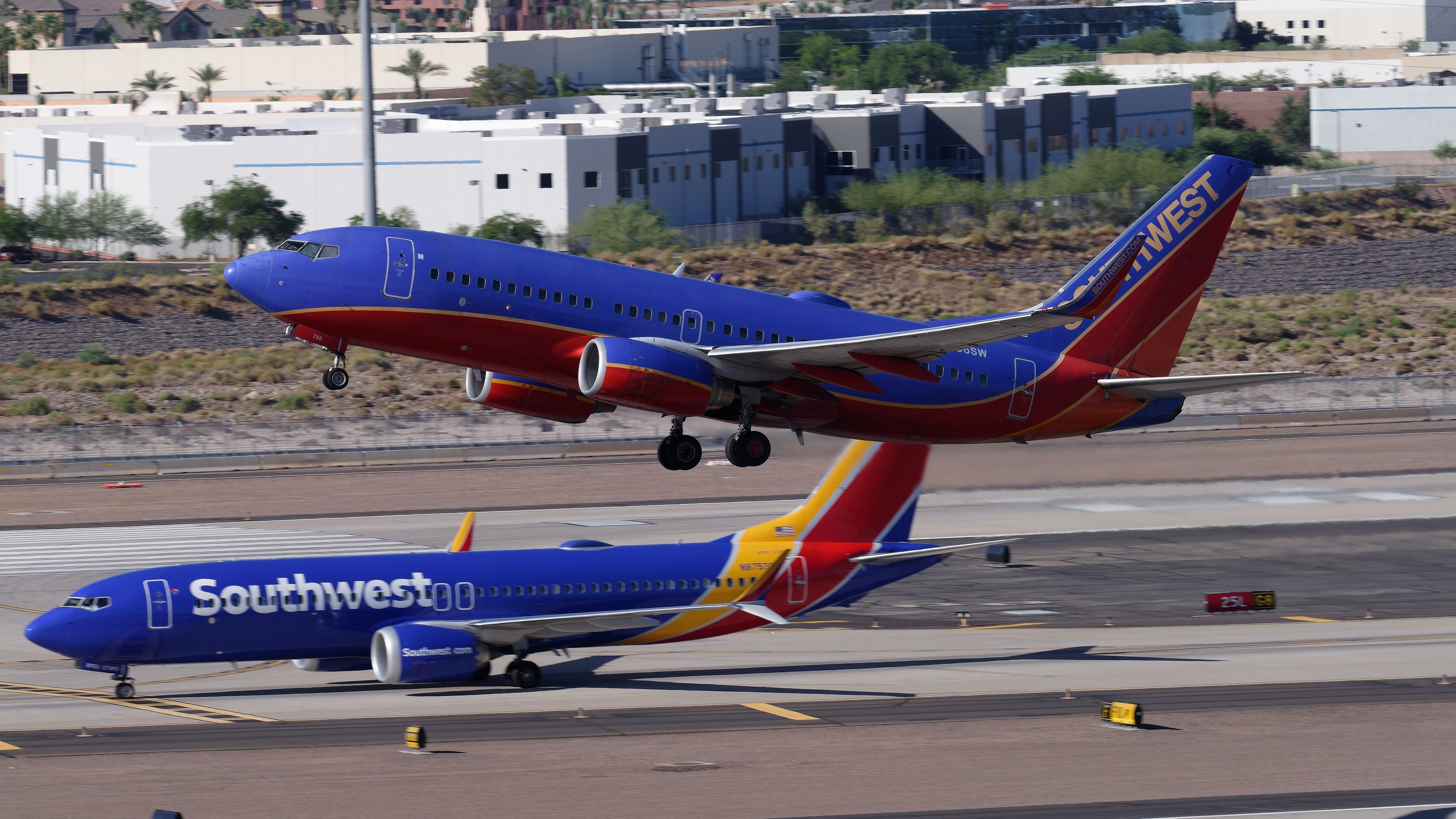 Two Southwest Airlines Boeing 737 aircraft at Phoenix Sky Harbor International Airport PHX shutterstock_2314329285