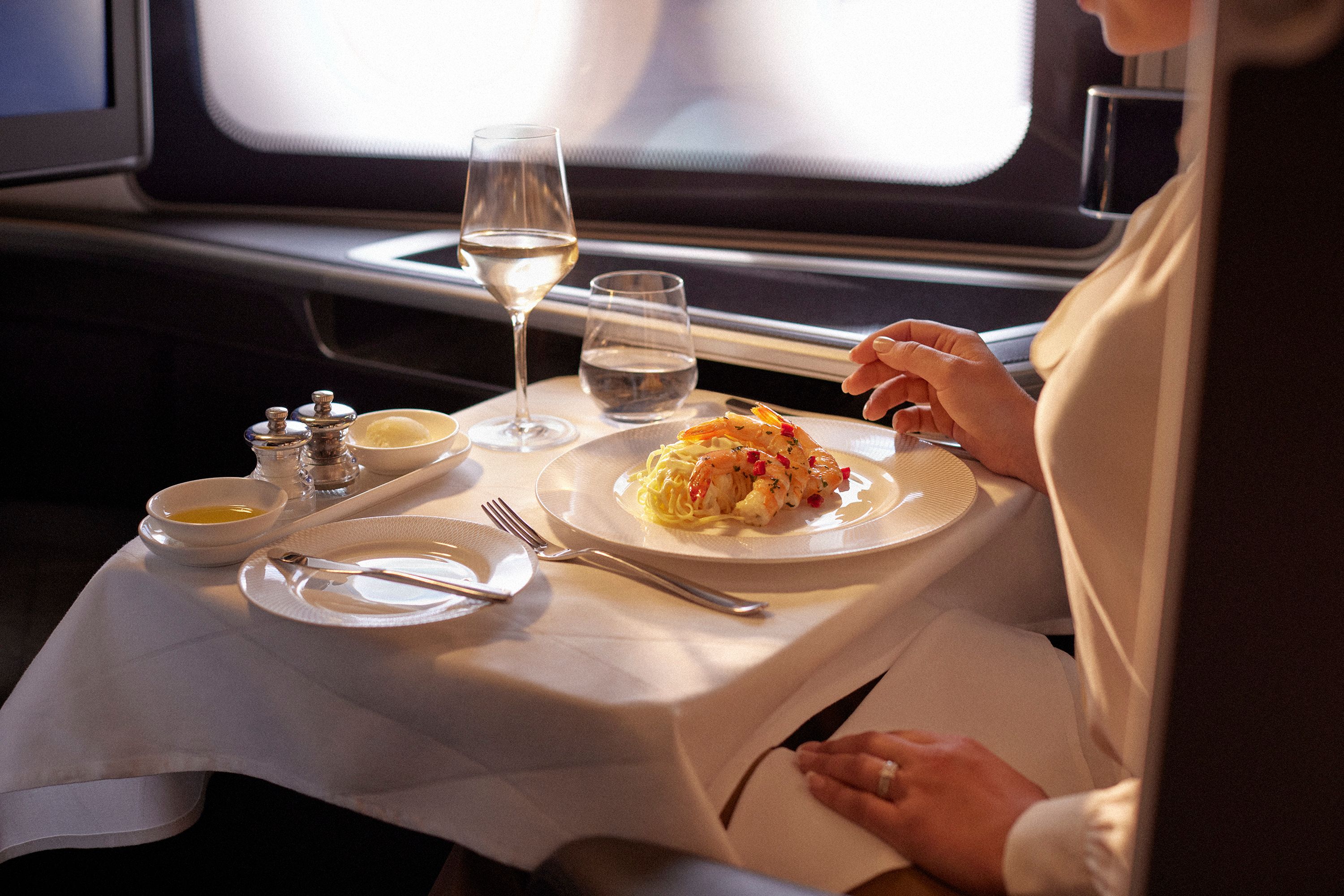 British_Airways-A_customer_enjoying_a_meal_in_First-ref181395