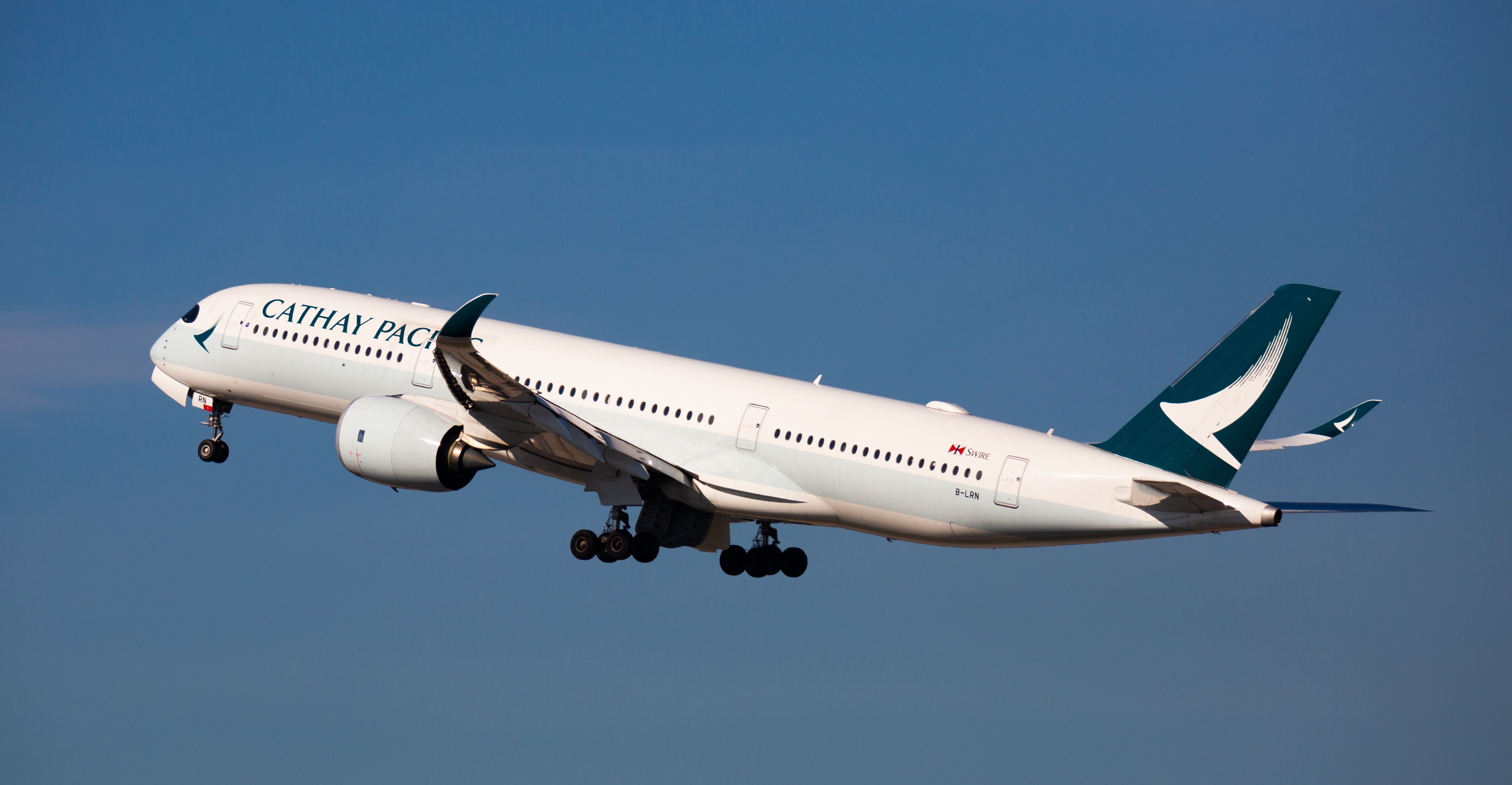 Cathay Pacific Airbus A350-900 departing BCN shutterstock_2212845381