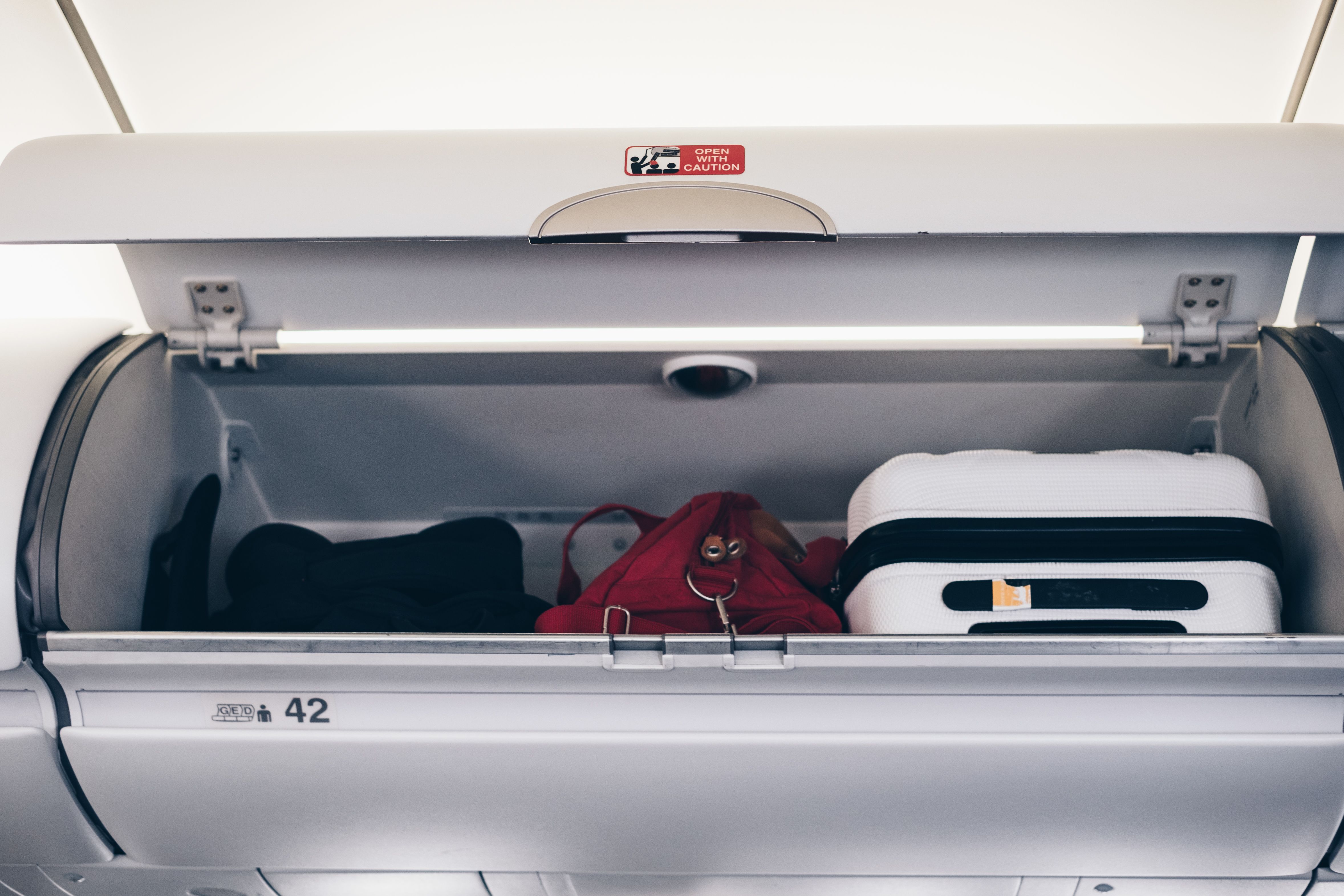 Overhead bin with personal items stowed