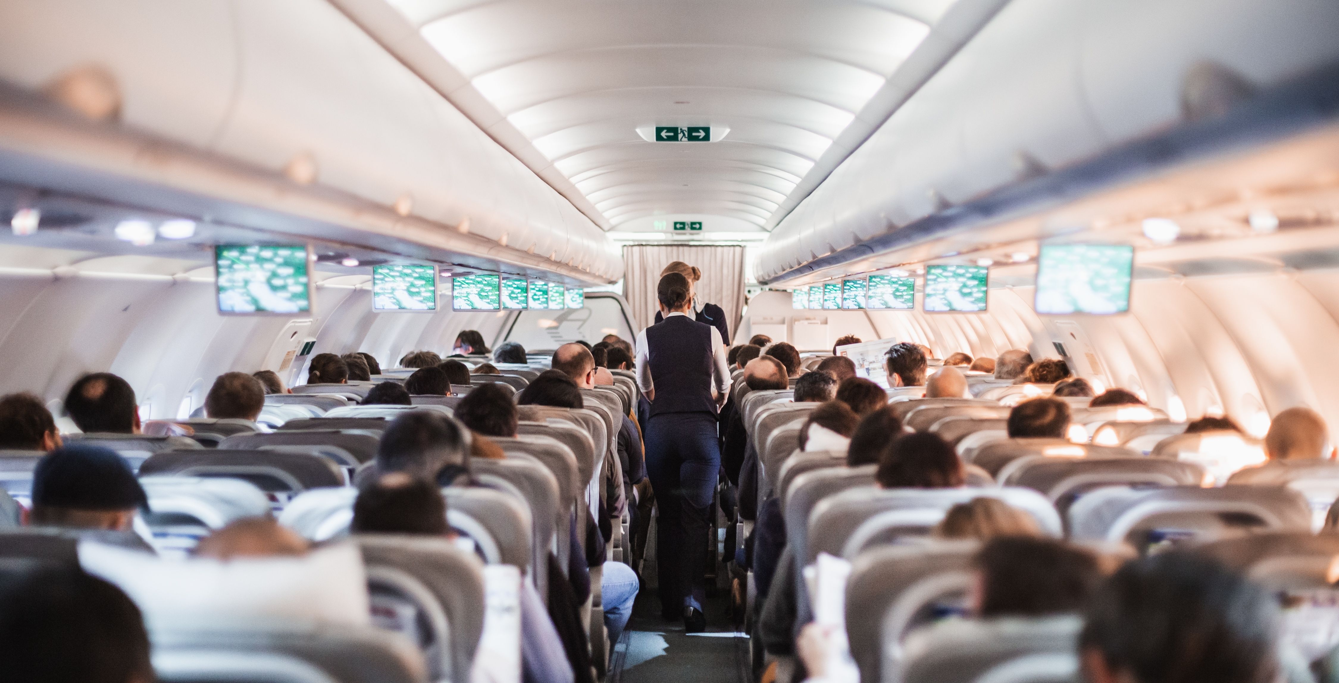 passengers seated in rear of aircraft