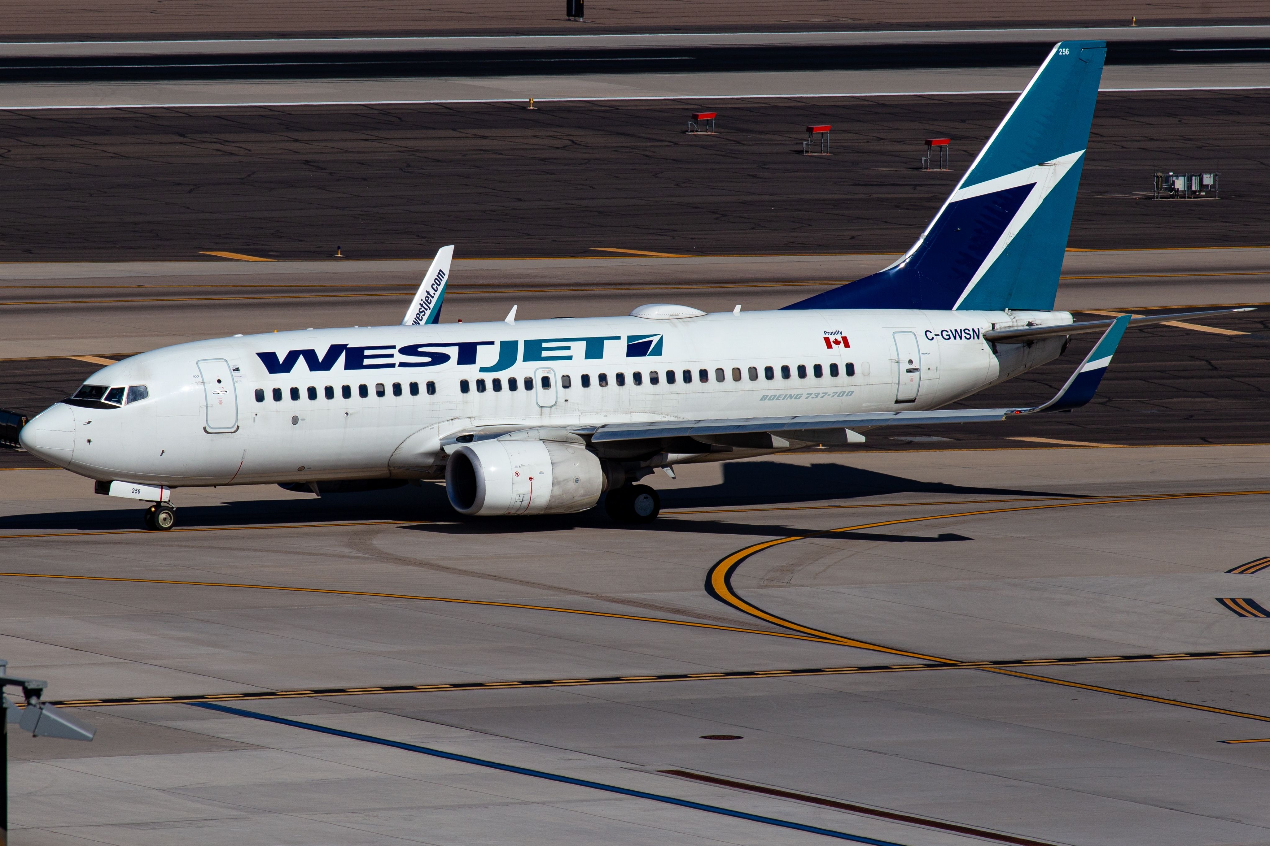 WestJet Boeing 737-700 taxiing at Phoenix Sky Harbor International Airport PHX shutterstock_2498863563