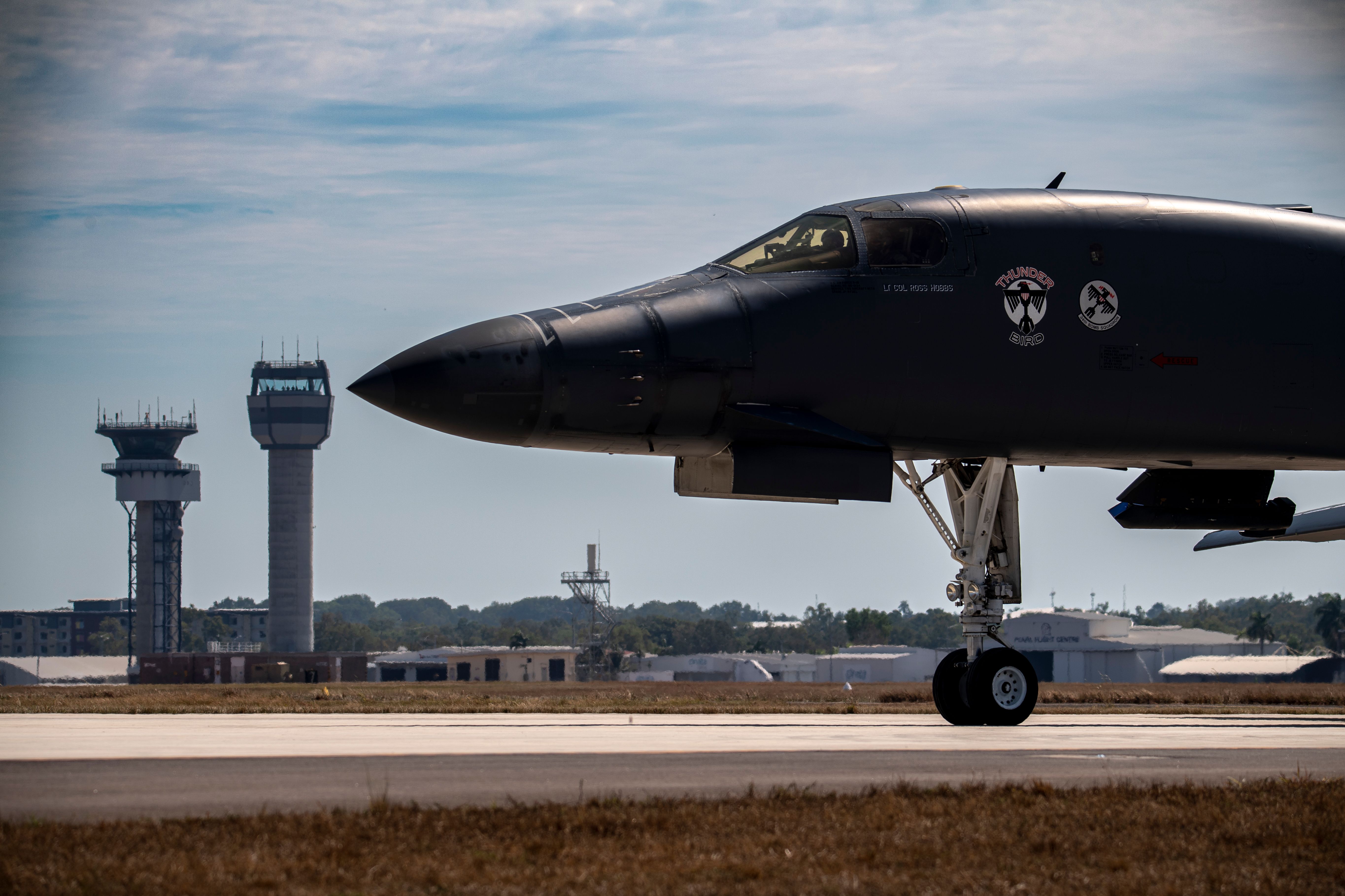 A B-1B Lancer, assigned to 34th Expeditionary Bomb Squadron, taxies past the control towers of the Darwin International Airport after landing at Royal Australian Air Force Base Darwin