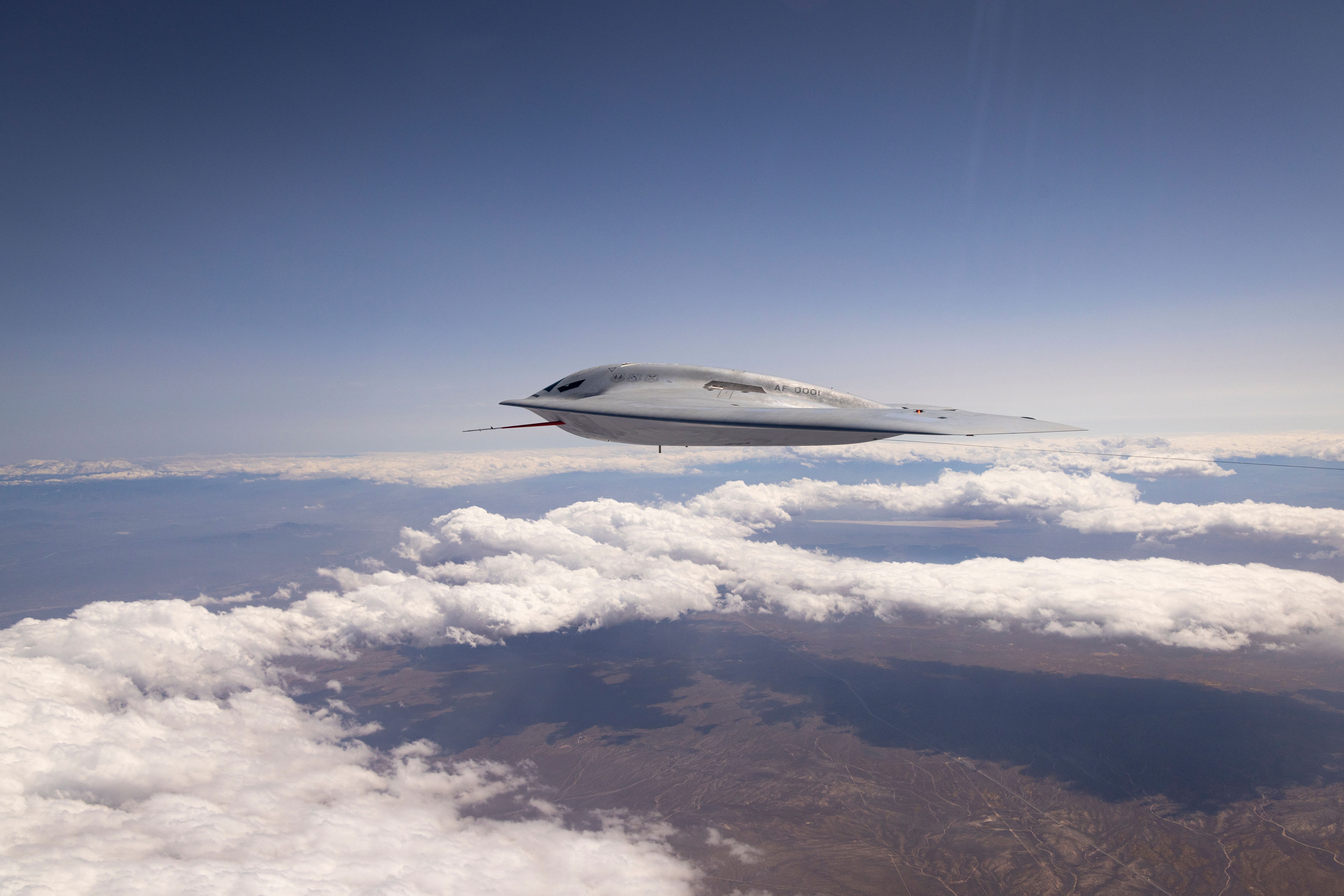 A B-21 Raider conducts flight testing, which includes ground testing, taxiing, and flying operations, at Edwards Air Force Base, California.