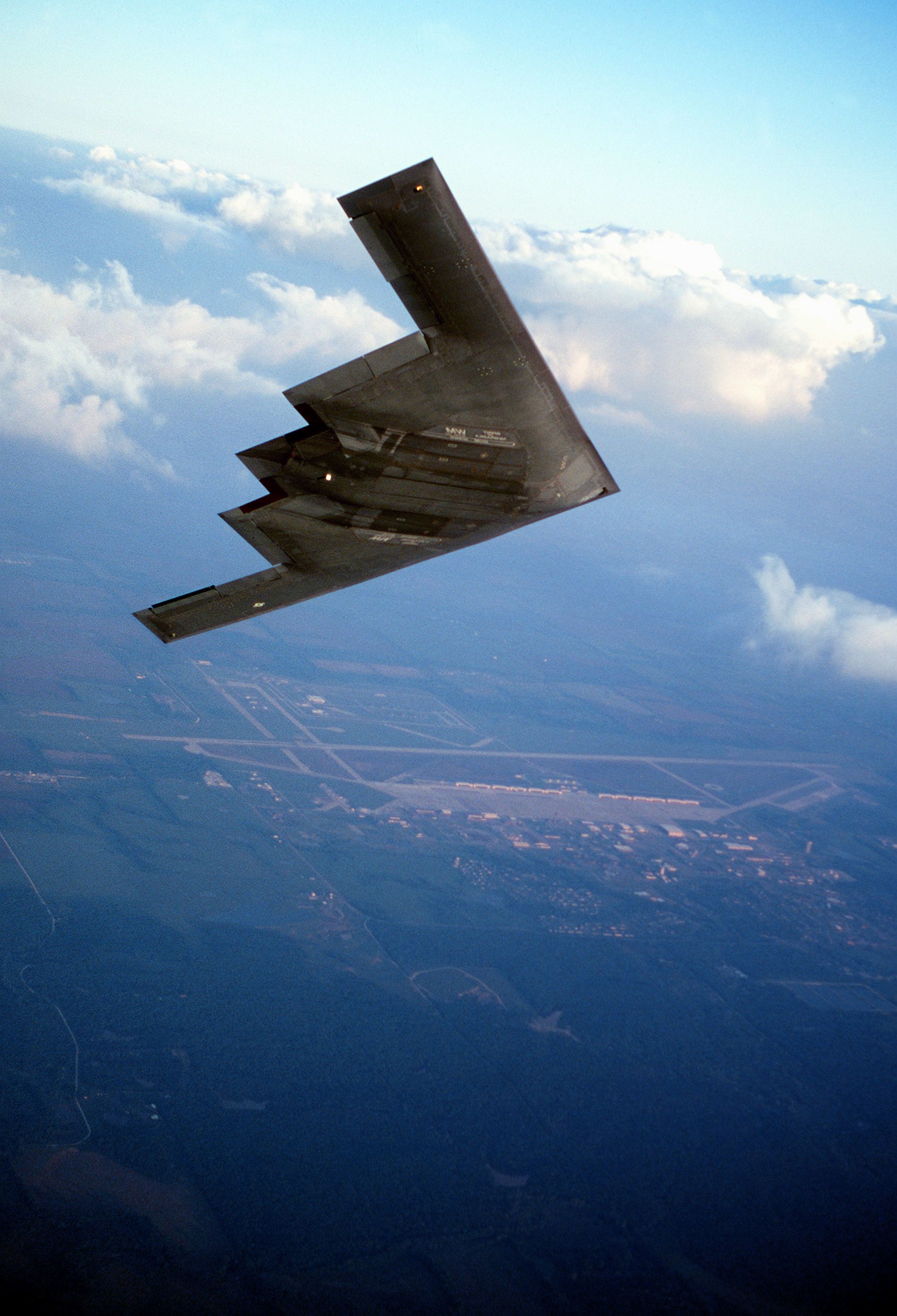 Air to air view of a Northrop-built B-2 Spirit bomber flying a sunset training sortie near the base. The B-2 is assigned to Air Combat Command, 8th Air Force's 509th Bomb Wing