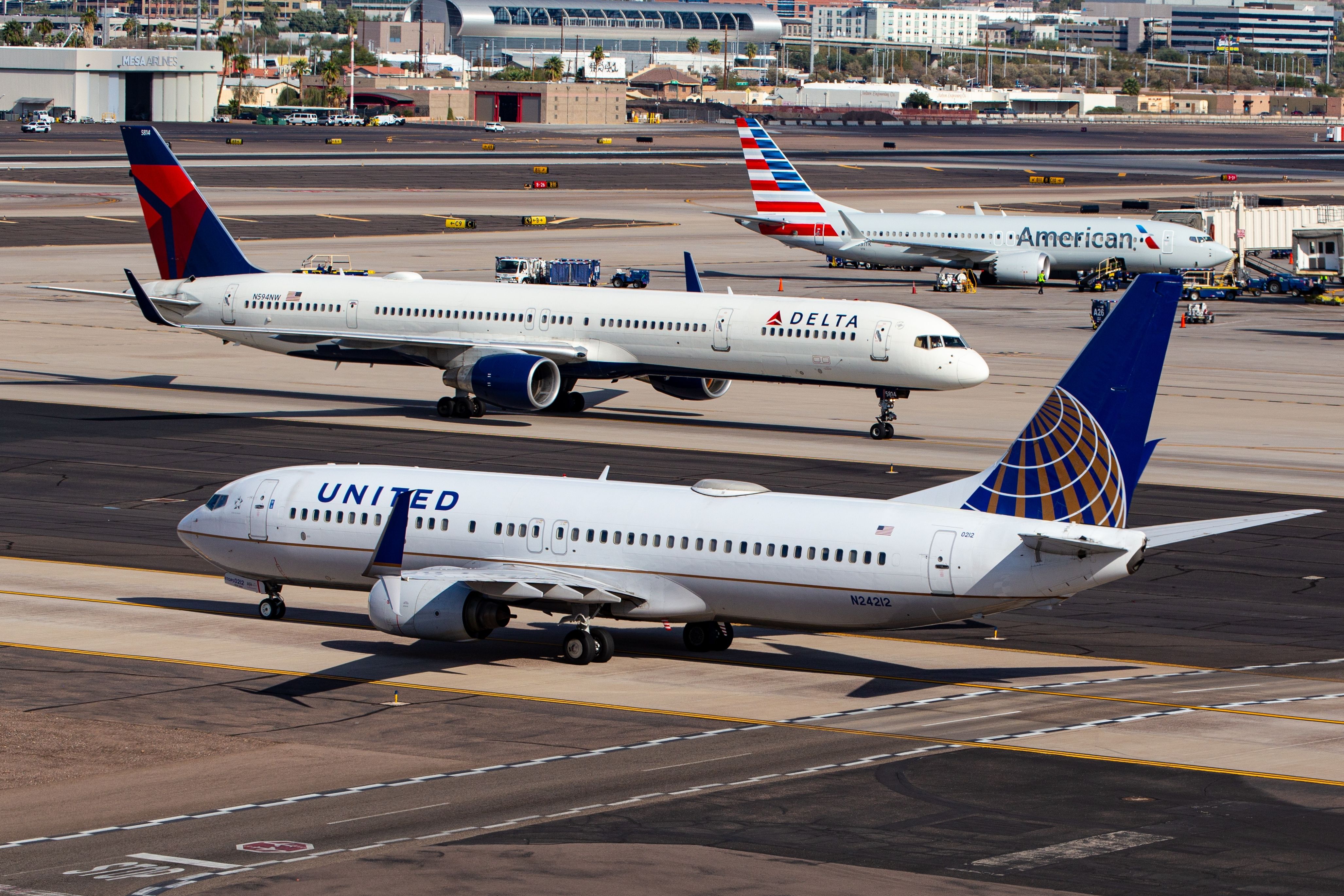 American Airlines, Delta Air Lines, and United Airlines aircraft at PHX shutterstock_2495762415