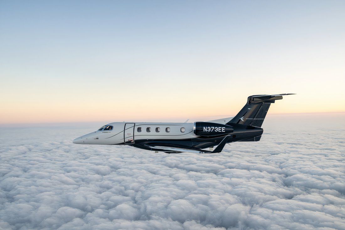 Phenom 300 flying above the clouds.