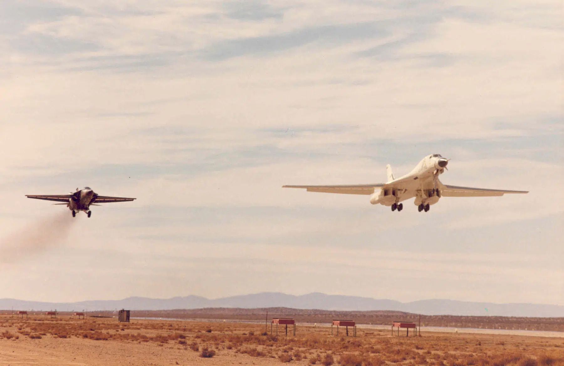Rockwell B-1A 74-0158 with a General Dynamics F-111 chase plane, landing at Edwards Air Force Base, California