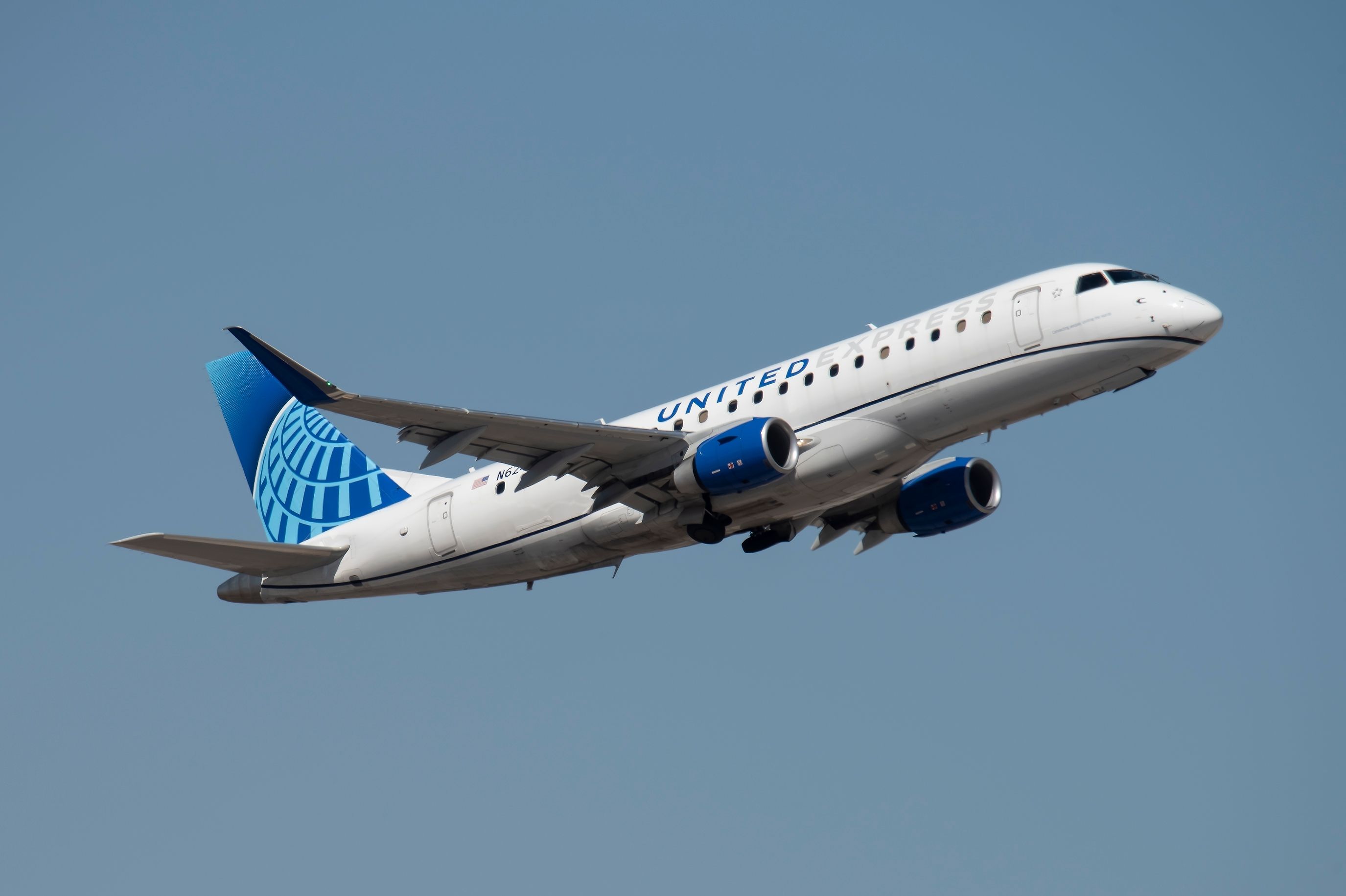 United Express E175 landing at PHX shutterstock_2271856359