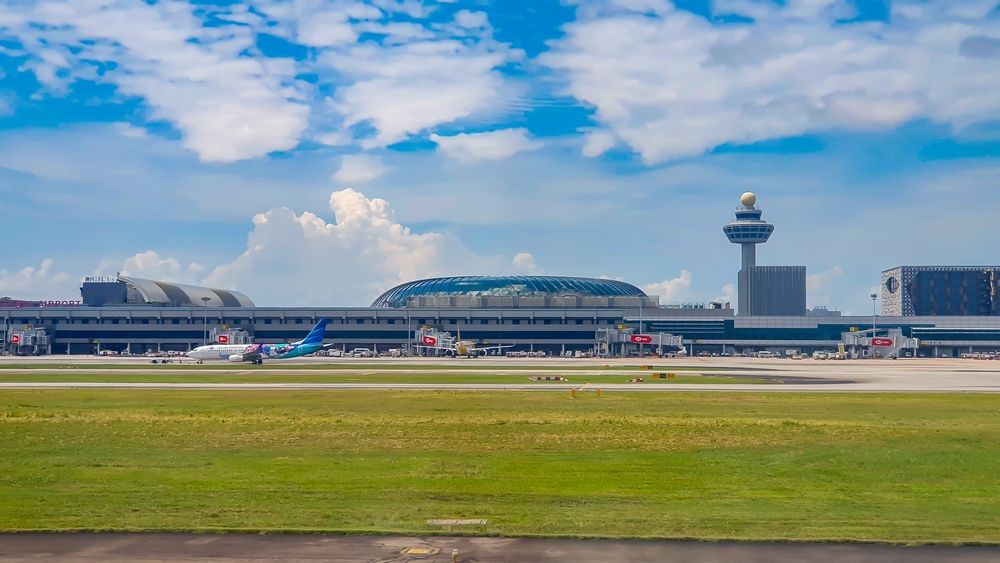 Panoramic view of the runway and marina of Singapore Changi Airport.