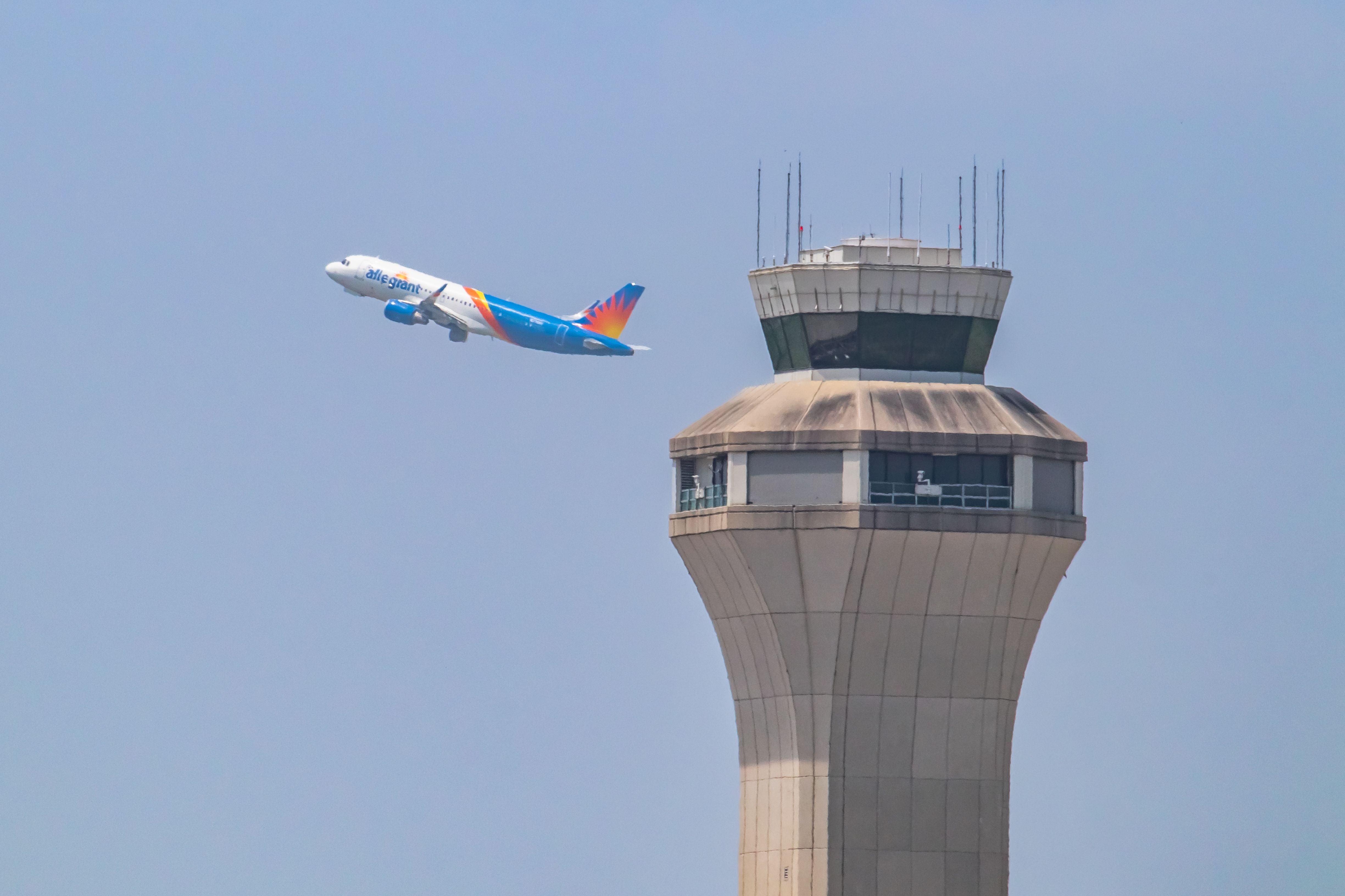 April 22, 2023 Austin-Bergstrom International Airport Allegiant Airlines taking off behind the Austin Bergstrom international airport ATC Tower