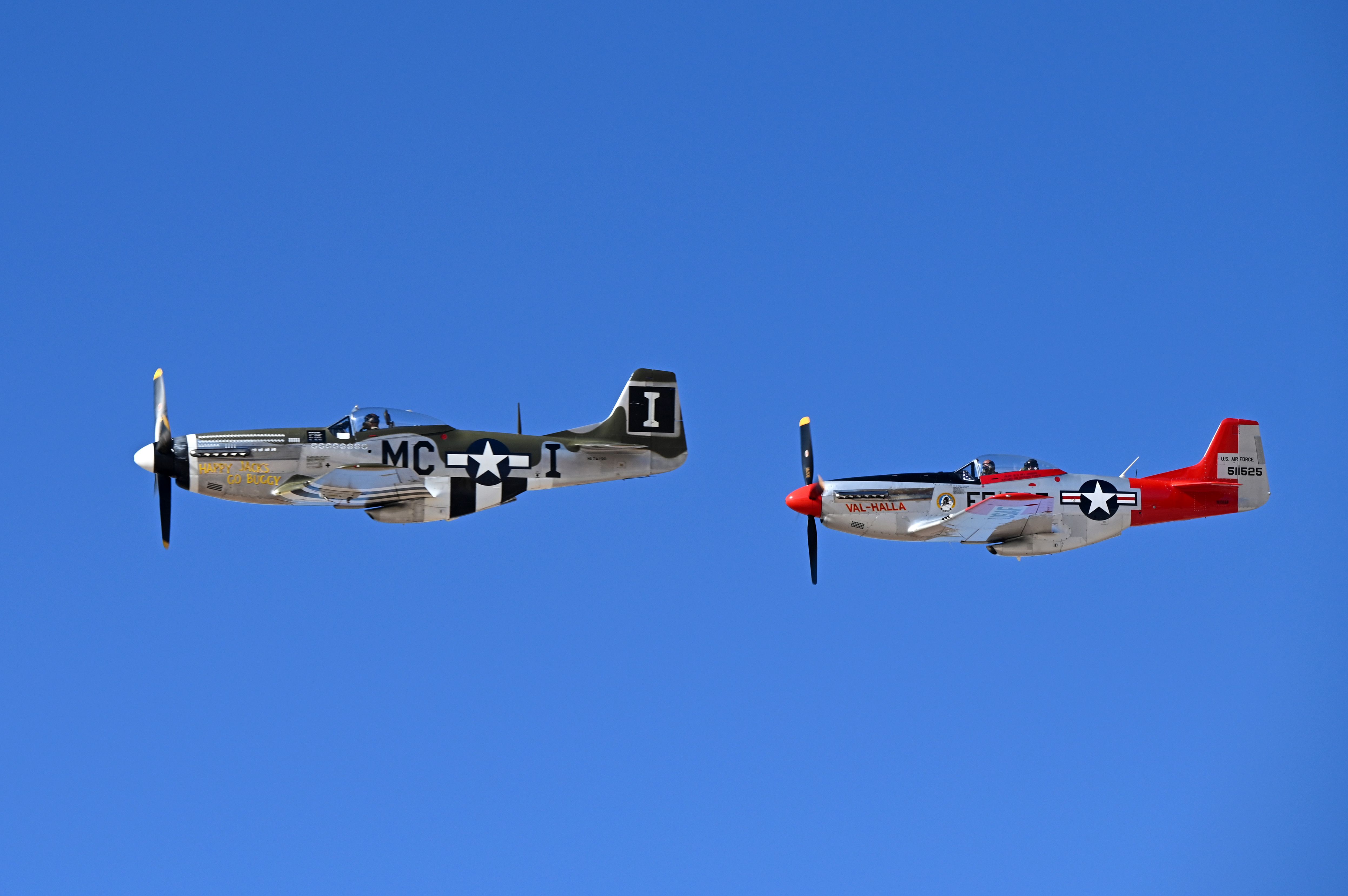 Two P-51 Mustang aircraft perform the second flight of the day as a two-man aerial demonstration during Heritage Flight Training
