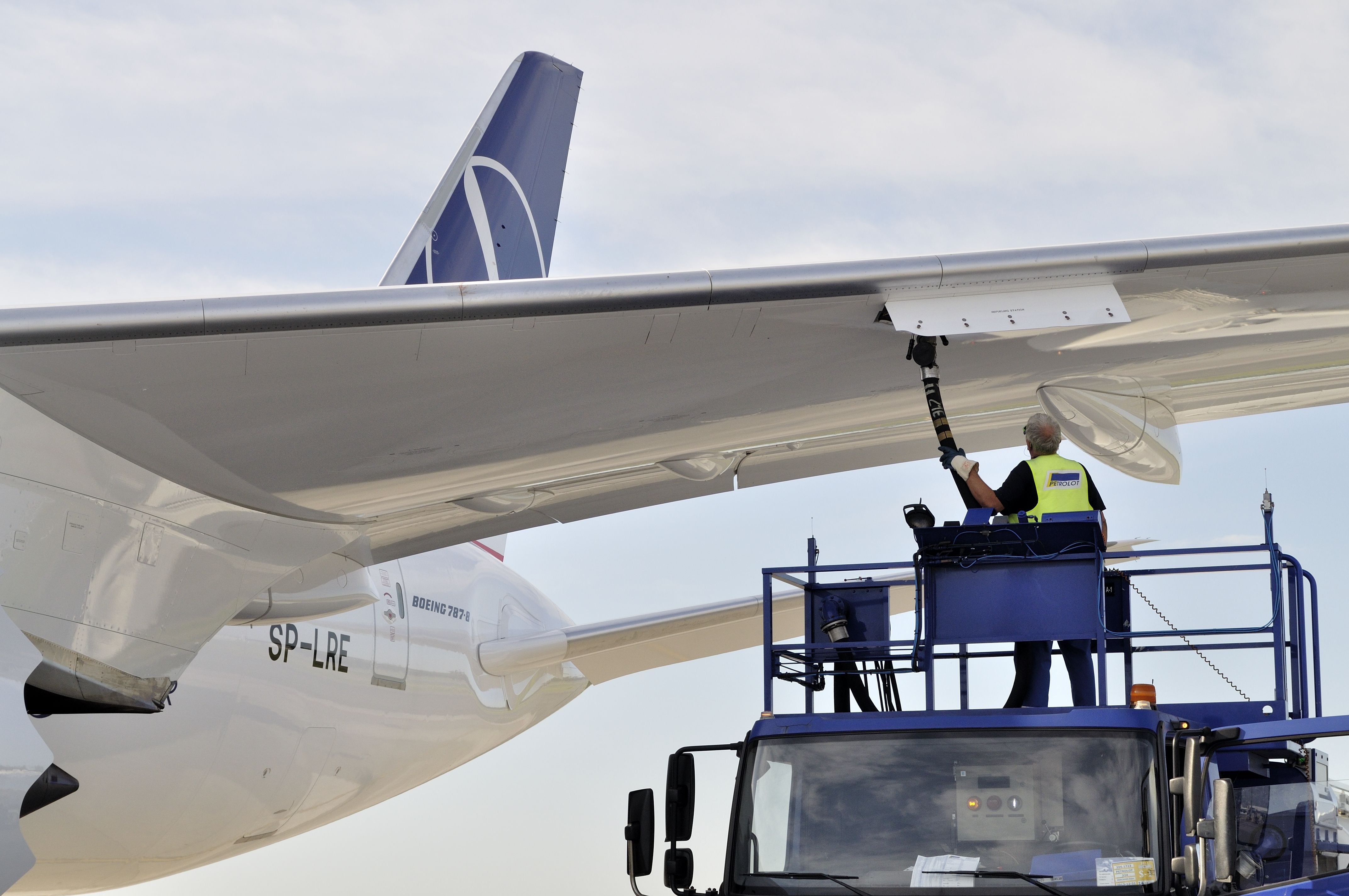 New Boeing 787 Dreamliner of the LOT Polish Airlines - receiving fuel from tanker truck at Chopin Airport