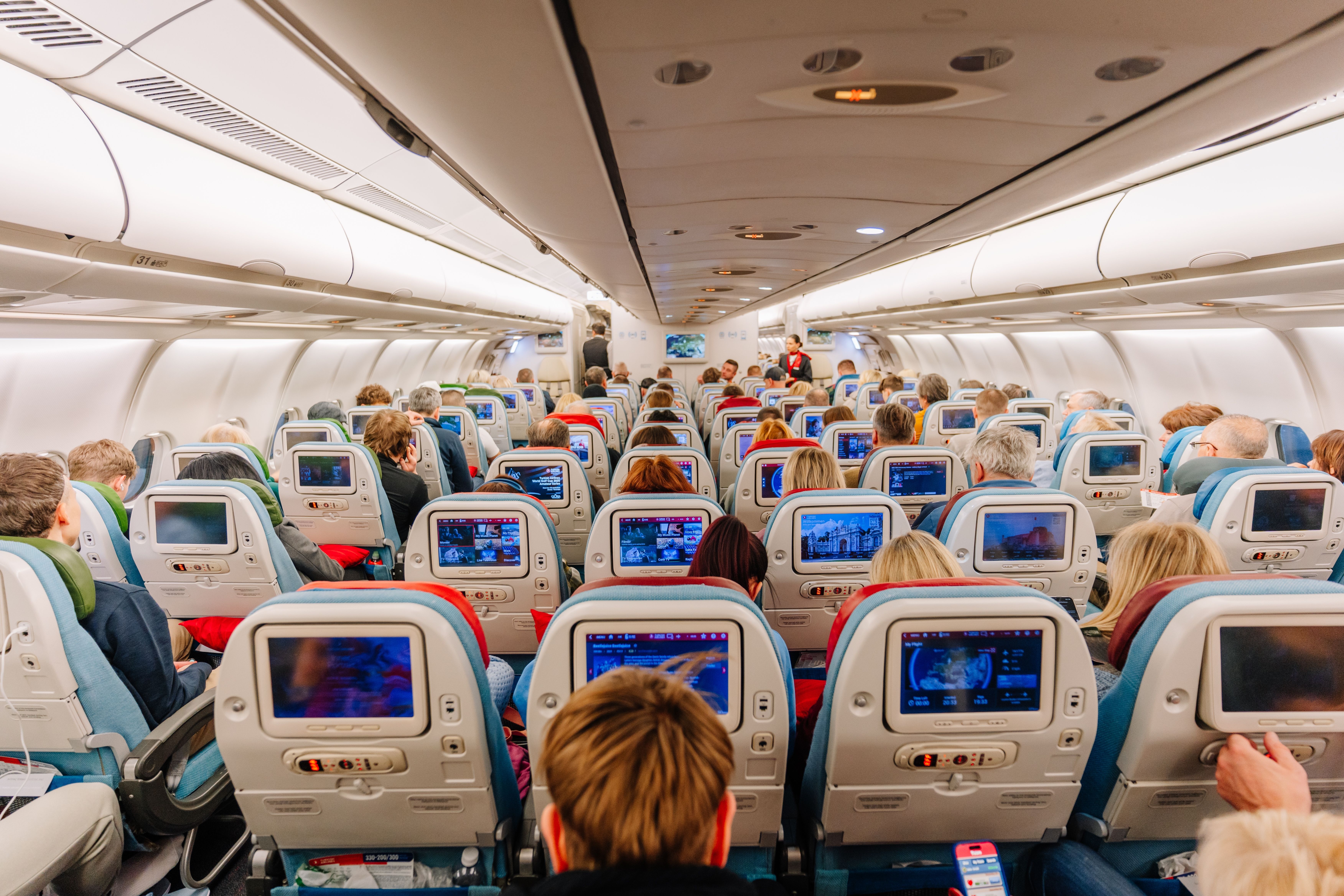 Aircraft cabin interior with in-flight entertainment screens