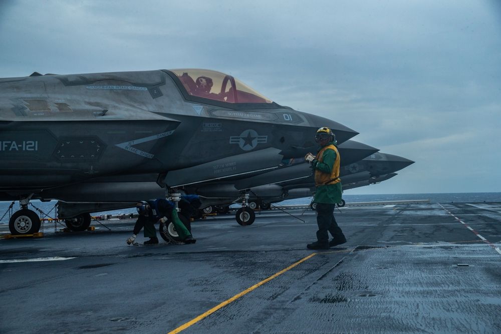 Sailors aboard amphibious assault ship USS America (LHA 6) prepare an F-35B Lightning II fighter aircraft