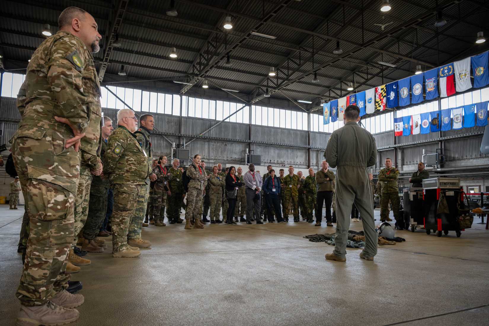 Air Force Capt. Thomas Sanchez, F-16 Fighting Falcon pilot assigned to the 480th Fighter Squadron, briefs representatives from 28 nations at Spangdahlem Air Base, Germany, May 15, 2025.