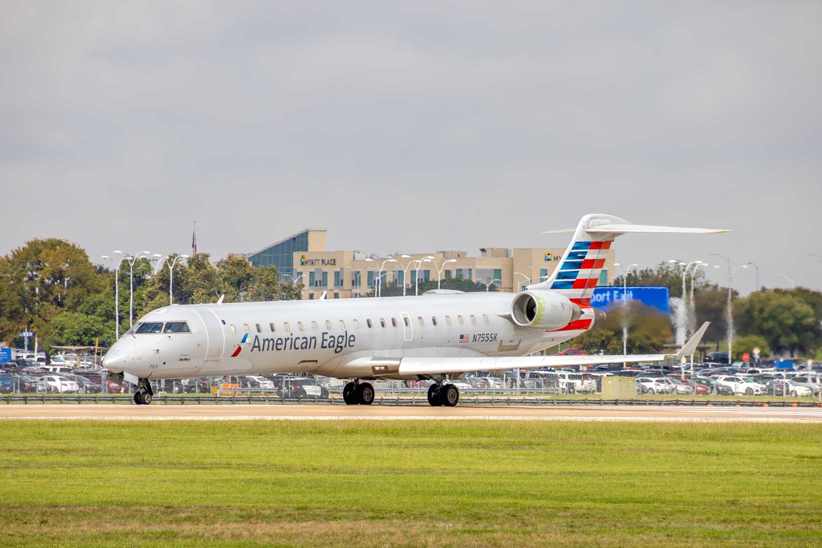 PSA Airlines - American Eagle Mitsubishi CRJ-701ER departing runway 18L at Austin Bergstrom International Airport.