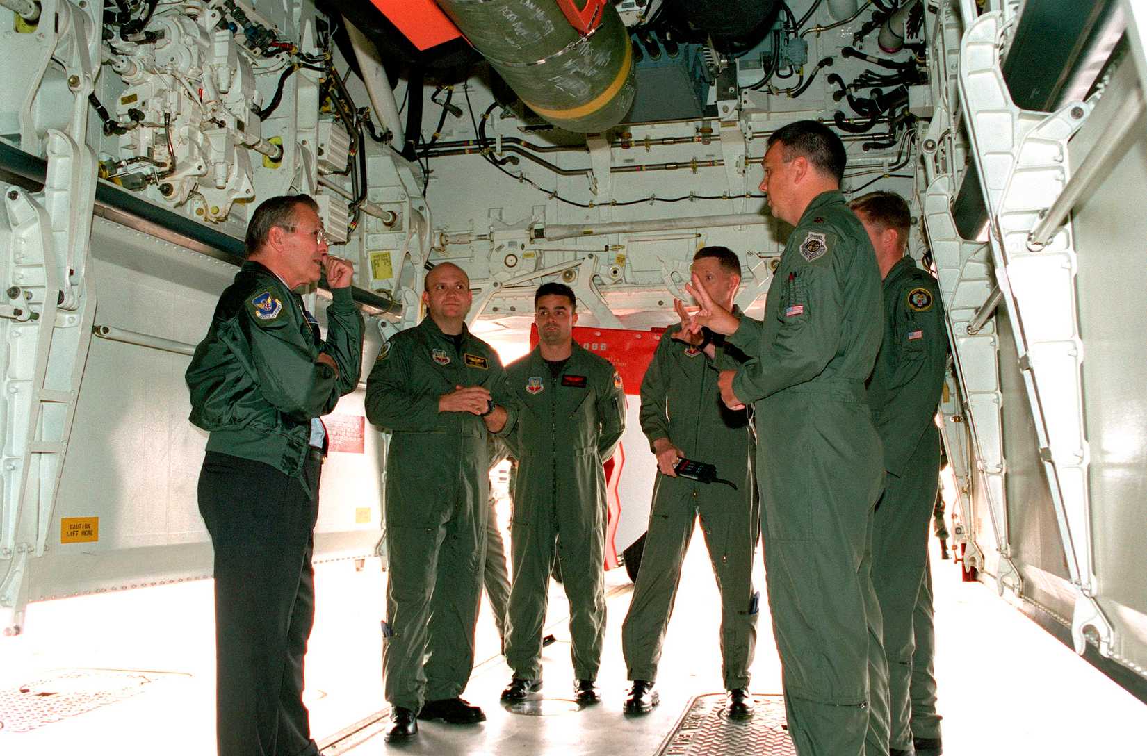 Secretary of Defense Donald H. Rumsfeld (left) stands under the open bomb bay of a U.S. Air Force B-2 Spirit bomber at Whiteman Air Force Base, Mo., on Oct. 19, 2001.